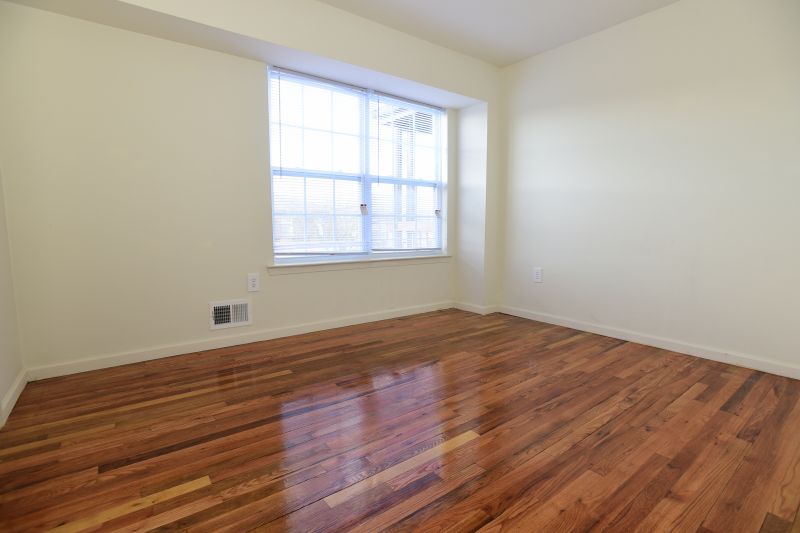 Woodbridge Center Plaza photo of a typical bedroom shows hardwood floor and a window to let in natural light.