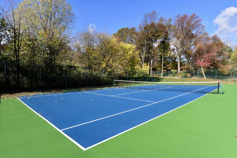 Photo showing the completely redone outdoor tennis court at Woodbridge Center Plaza