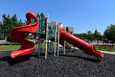 Fox Hill Run image of the community playground shows a large piece of kids equipment with multiple slides.