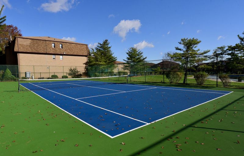Photo showing the completely redone outdoor tennis court at Woodbridge Terrace.