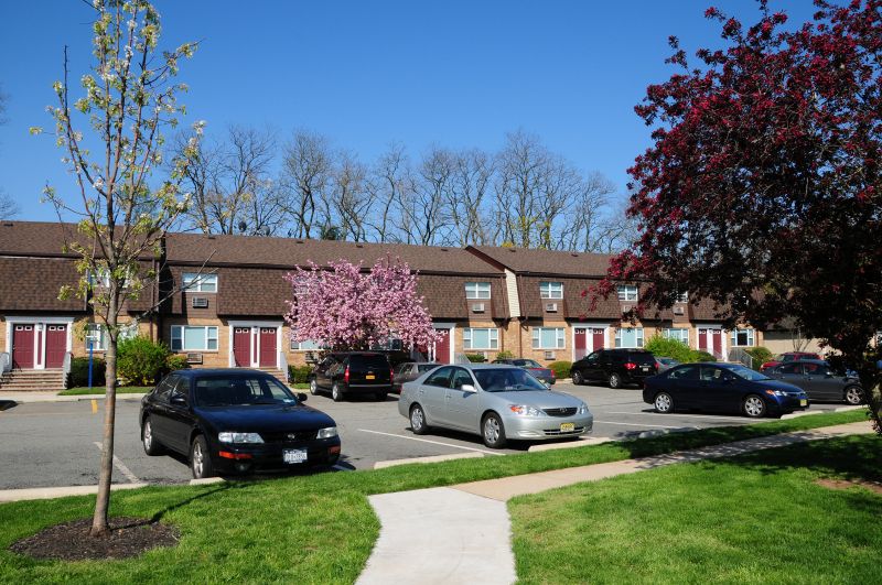 Woodbridge Village exterior image shows an apartment building in the