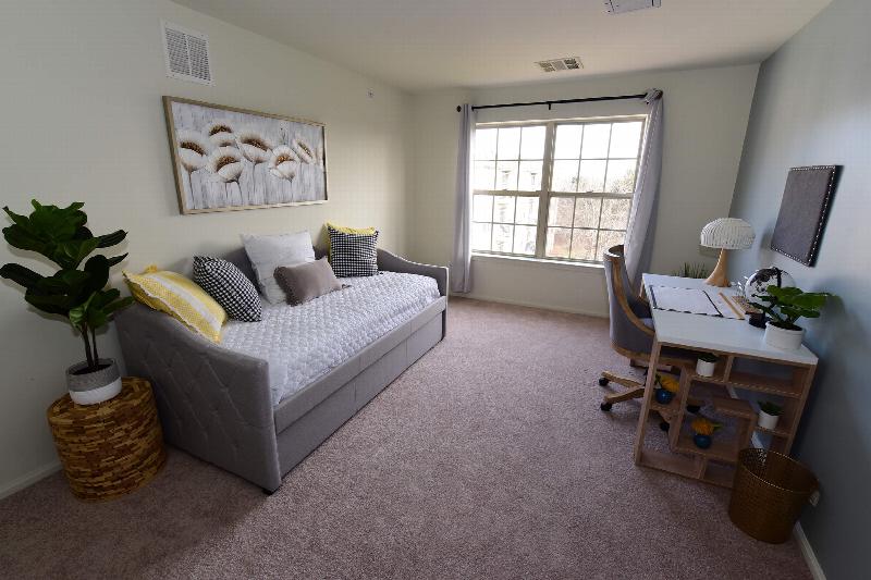 Yorkshire Village exterior showing several balconies. Several bushes and trees highlight the landscape.