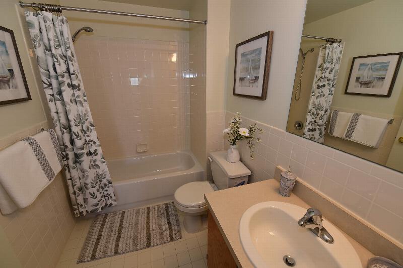 Yorkshire Village exterior showing several balconies. Several bushes and trees highlight the landscape.