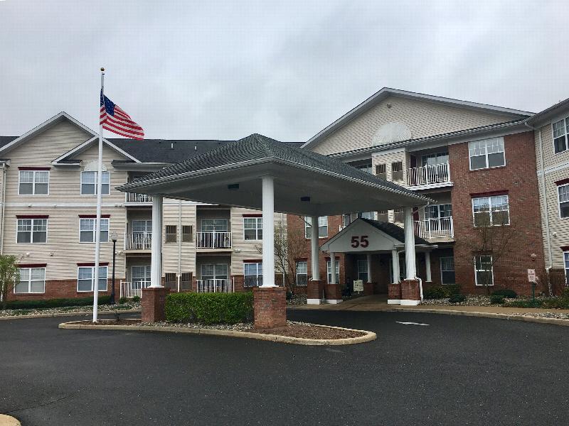 Hyde Park Exterior photos showing a vinyl and brick exterior with several balconies. The entrance to the building and a sign for the Rental Office can be seen.