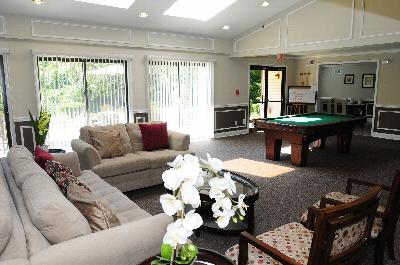 Edison Woods Seniors for ages 55 and over community room image shows a searing area and pool table.
