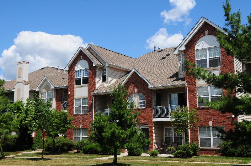 Pike Run Affordable Exterior photo showing several balconies. Several bushes and trees highlight the landscape.