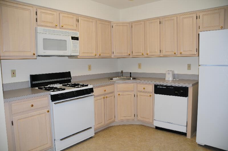 Pike Run Affordable Kitchen photo showing maple color cabinets, white appliances and ceramic tile flooring.