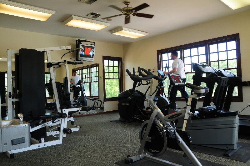 Pike Run Affordable Gym photo showing two ellipticals, an exercise bike and various exercise equipment.