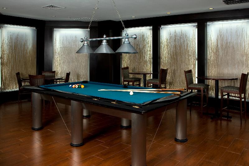 Helix at Xchange Affordable photo of amenity room showing a large billiard table.  Bar height tables and seating can be seen in the back ground. 