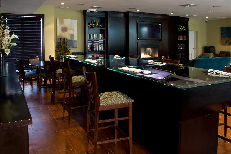 Helix at Xchange Affordable photo of amenity room showing several computer work stations. Fireplace and additional seating can be seen in the background.   