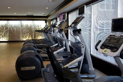 Helix at Xchange Affordable photo of gym room shows several treadmills, elliptical machine and various other gym equipment.