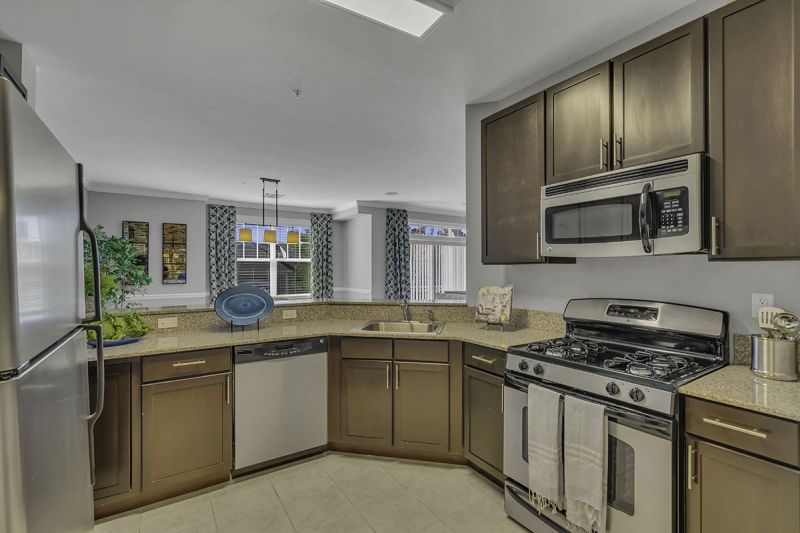 Interior Photo of the model at Princeton Terrace at West Windsor showing the kitchen with beautiful cabinets and countertop, along with stainless steel appliances