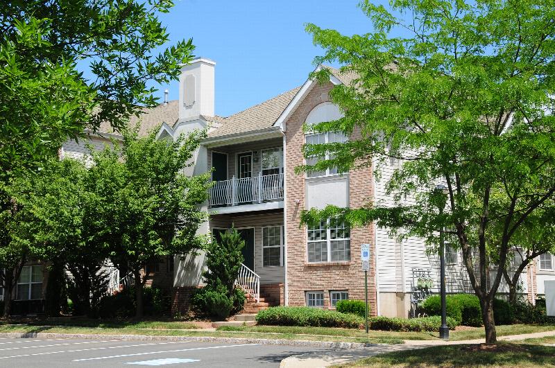 Pike Run Village Exterior photo showing several balconies and a streetlight. Several bushes and trees highlight the landscape.
