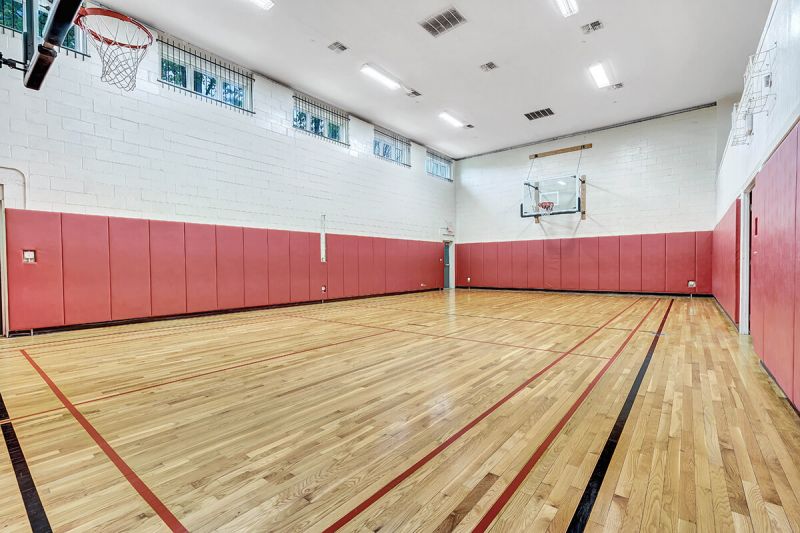 Interior photo of the Pike Run Community Clubhouse, showing the indoor, full basketball court.