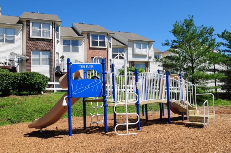 Photo of one of the playgrounds located at Harbortown. There is a piece of play equipment with stairs and a slide.