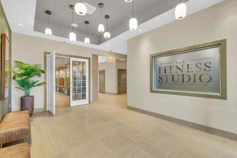 Interior photo of the the clubhouse at Woodhaven showing the common hallway leading to the Fitness Studio