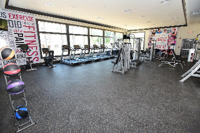 Station Village at Avenel photo of the gym shows many pieces of exercise equipment including multiple treadmills, stationary bikes and strength training machines.