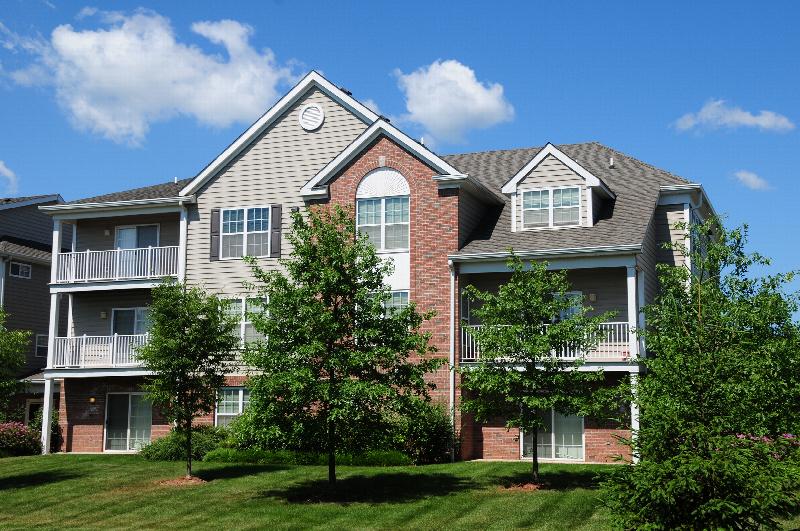 Pike Run Meadows Exterior photo showing several balconies. Several bushes and trees highlight the landscape.
